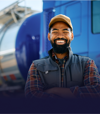 Smiling trucker standing next to his truck