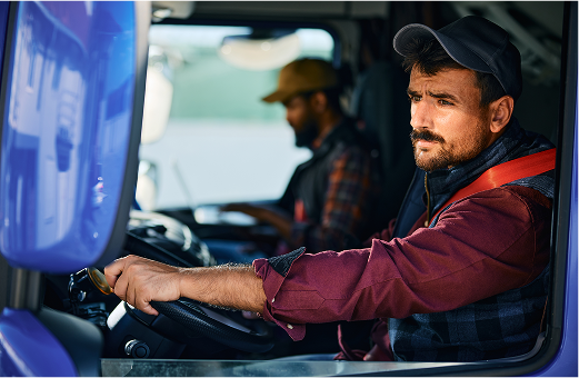 Truckers sitting in the front seat of a truck